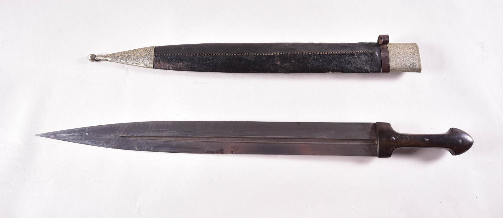 Large Antique Caucasian Kindjal or Quaddara: Large Antique Caucasian kindjal or Quaddara with dark horn grip scales, scabbard with engraved silver chape and locket and gold Damascened iron belt loop, plain blade with single fuller in fine condit