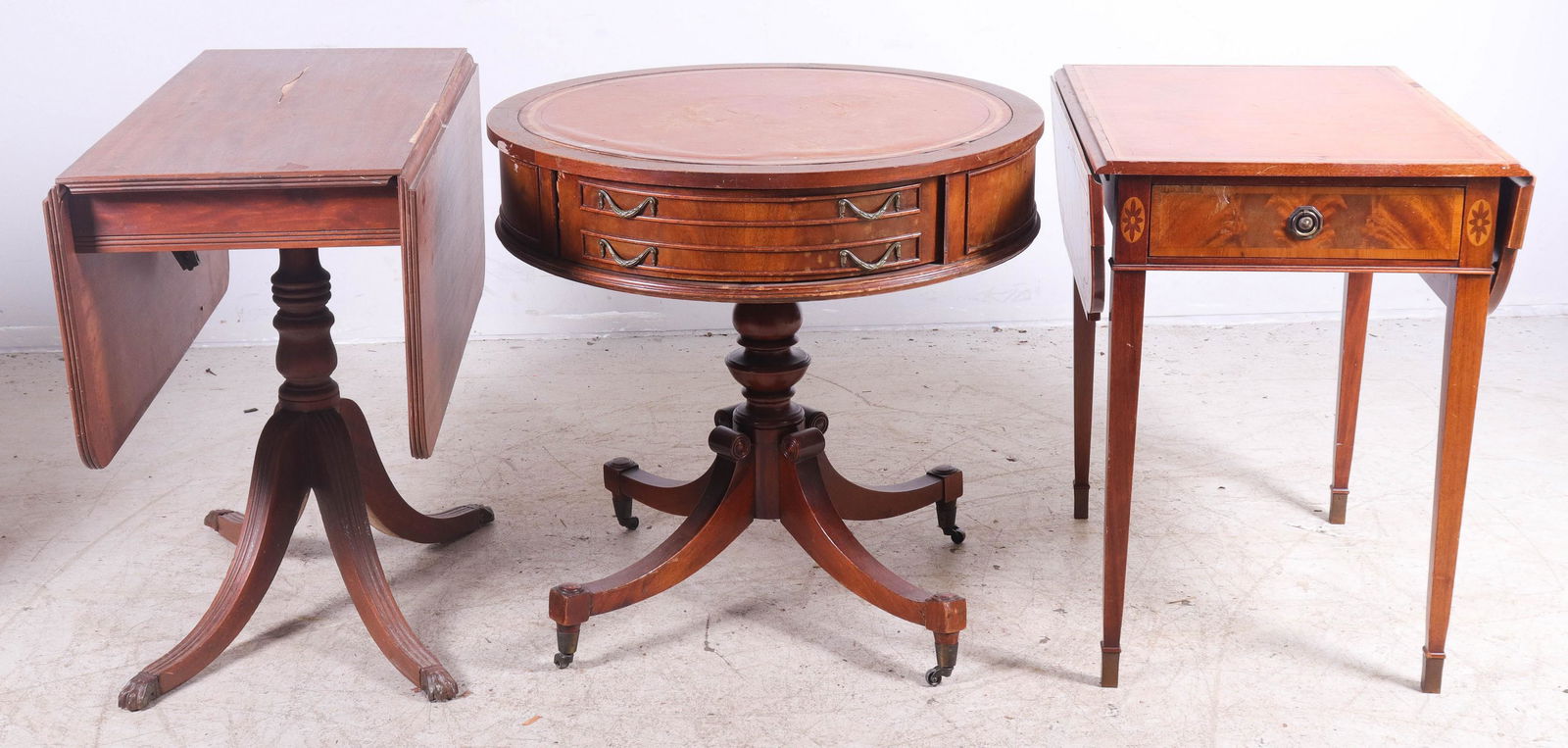 Leather Top drum table, (2) drop leaf tables: Round mahogany leather top drum table, 30"diameter x 48"h, Mahogany Duncan Phyfe drop leaf table, loss on top, Inlaid Pembroke dropleaf table one drawer
