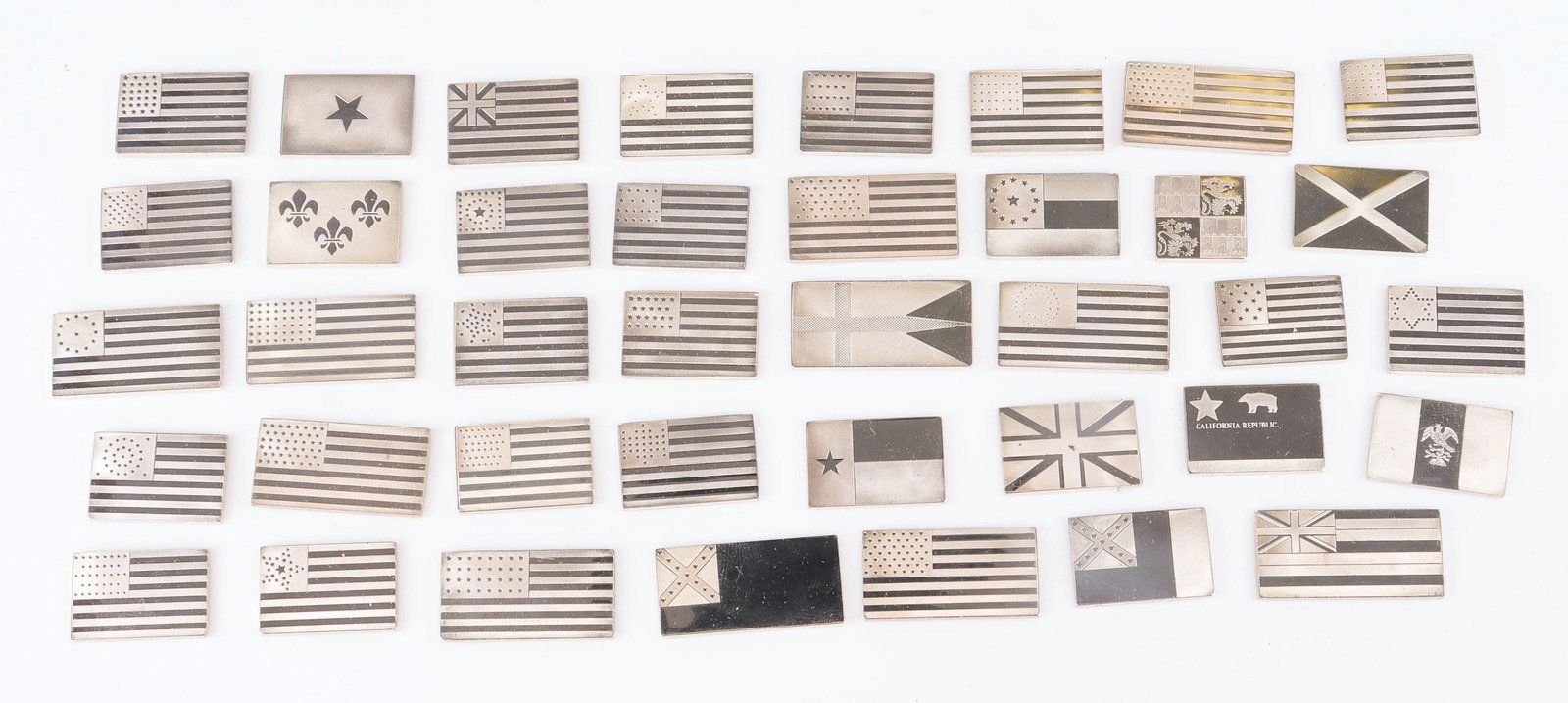 Assorted Sterling Miniature Flags: Assorted sterling miniature flags including several iterations of US and other countries, 6.29 TO, The largest is 1-1/4” x 5-8”.