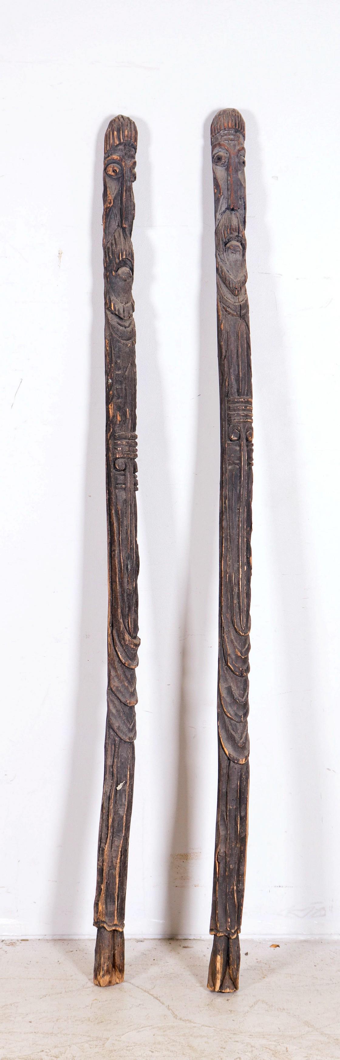 Pair of African Carved Wood Staffs: Pair of African carved wood staffs or poles, men with beards, 79" h