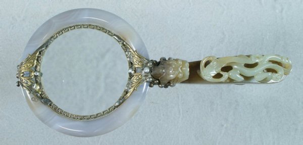 Jade, agate, and mixed metal magnifying glass, the: Jade, agate, and mixed metal magnifying glass, the dragon carved belt buckle handle mounted to a banded agate ring with brass and pewter ornamentation containing a double sided convex magnifying glass