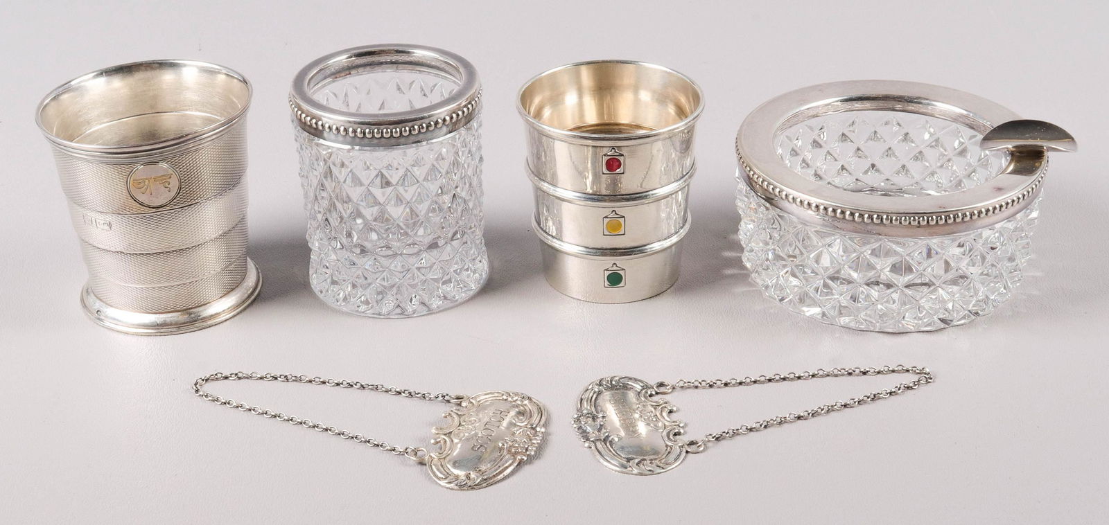 (6) Sterling Jiggers, Smoking Set and Bottle Tags: (6) Sterling jiggers, smoking set and bottle tags to include Gorham stoplight jigger, small dent at foot, 2-1/2" H, late 19th C Thomas Johnson collapsible jigger, London, 800 silver banded smoking set