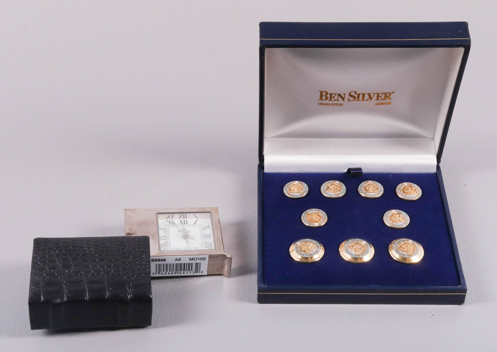 Ben Silver Buttons and Bulova Travel Clock: Ben Silver buttons and Bulova travel clock to include (9) Ben Silver Charleston South Carolina buttons in enamel decoration and Bulova quartz travel clock in faux crocodile cover.