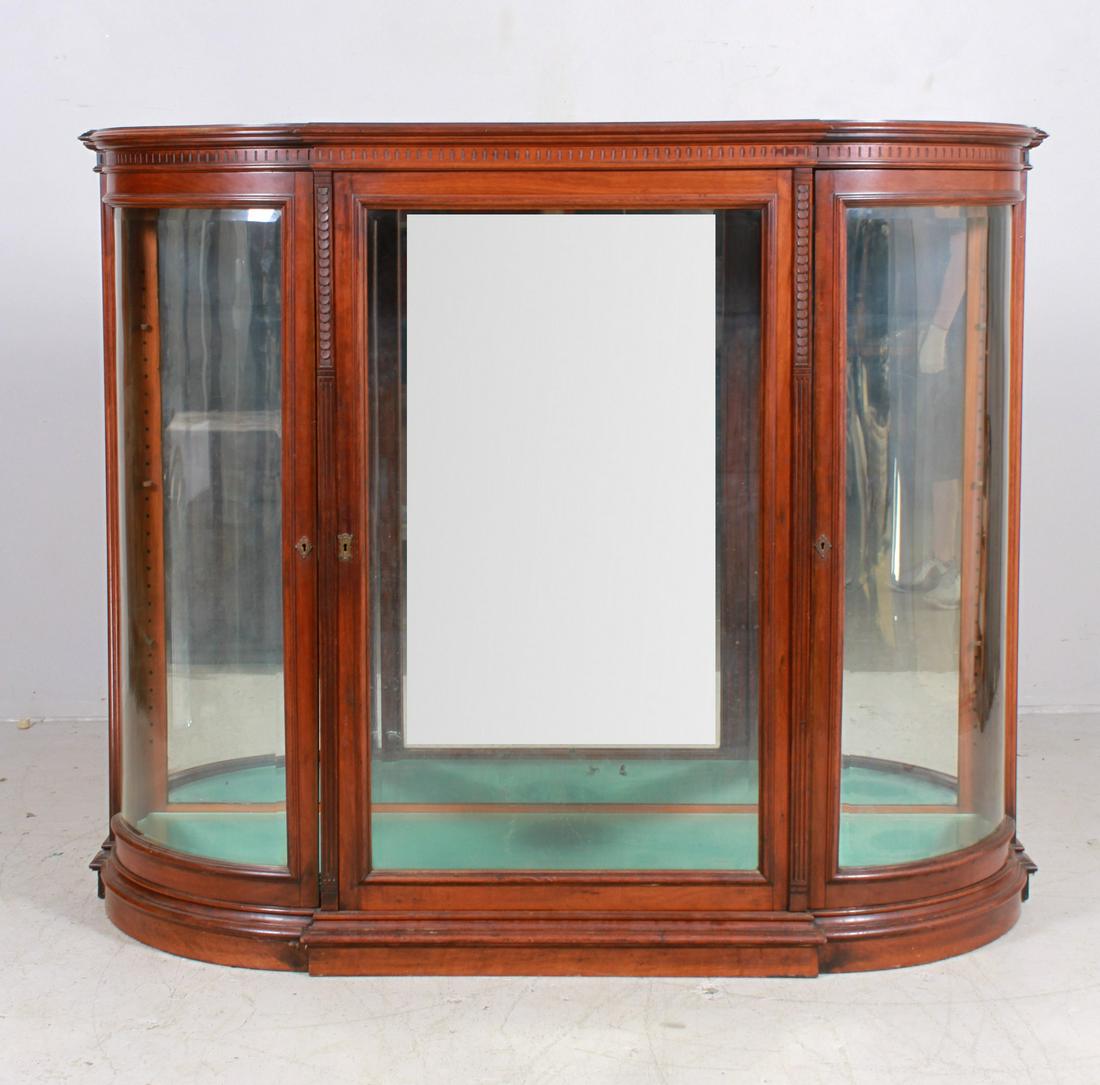Mahogany Victorian Bowed & Beveled Display Cabinet: Mahogany Victorian Bowed & Beveled Display Cabinet, door and end glasses with beveled edges, some cared detail at cornice and on columns flanking the door, mirrored back with 3 glass shelves, 68" wide