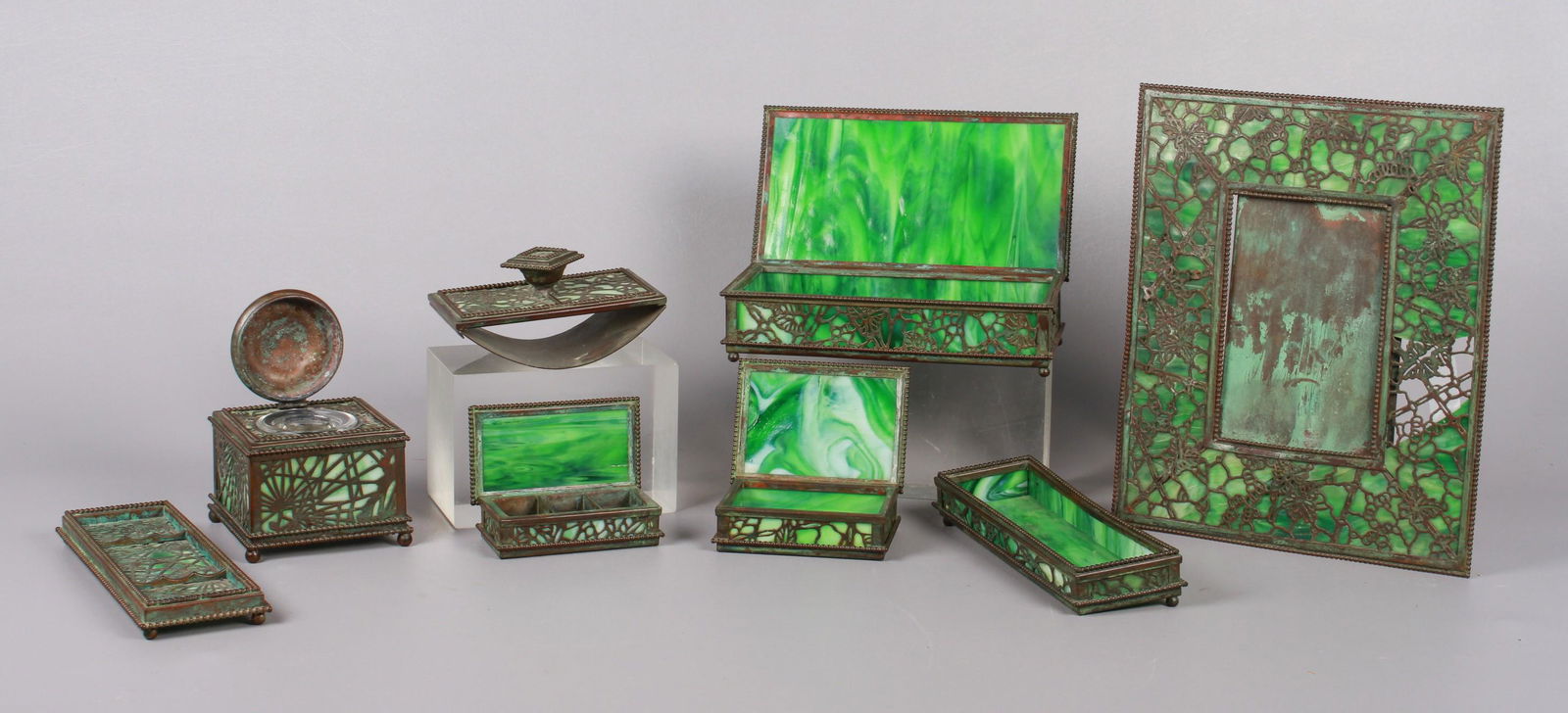 7-Piece Riviere & Tiffany Studios Bronze Desk Set: 7-Piece Riviere Studios bronze & green slag glass desk set, Grapevine pattern, c/o inkwell with clear glass insert (4-1/8" sq x 3-3/4" h), open box (8-3/8" x 2-7/8" x 1-1/2" h, missing one ball foot,