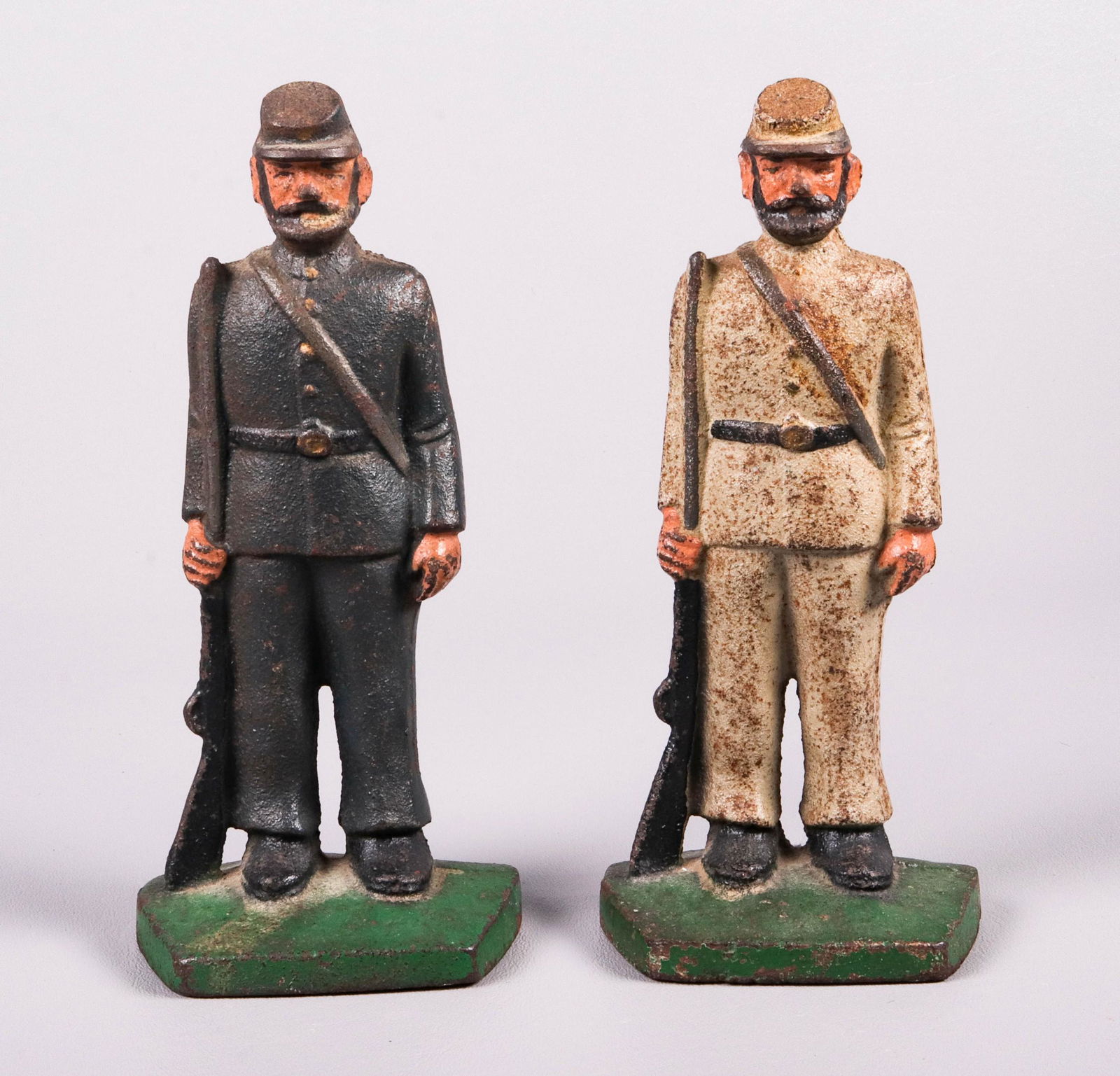 Pair of Cast Iron Civil War Soldier Bookends: (2) Cast iron Civil War bookends or doorstops, c/o one portrayed as a Union soldier, the other as a Confederate soldier, 7-1/4" h, some paint loss & rust