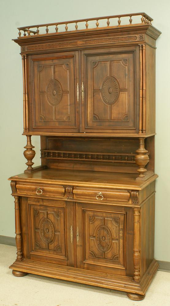 Carved 2 part walnut Continental dining room cupbo: Carved 2 part walnut Continental dining room cupboard, geometric carving on door panels, spindled gallery above cornice and midshelf, 49" w, 94" h, 23" d, 19th century, French or Belgian