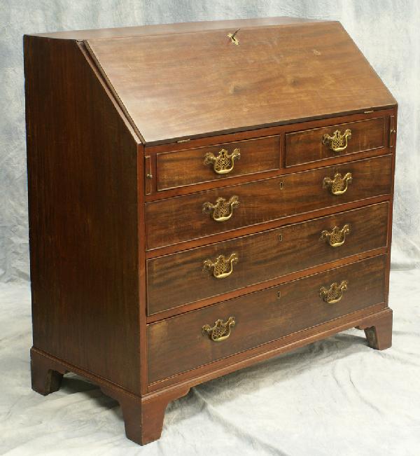 Mahogany Georgian slant front desk, 2 short over 3: Mahogany Georgian slant front desk, 2 short over 3 long drawers, flat interior, pierced batwing brasses, not original, raised on slightly flared bracket feet, likely original, late 18th century, 42 1/