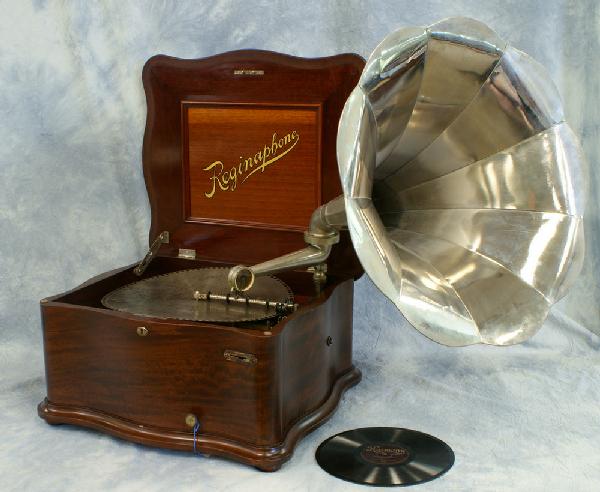 Reginaphone Model 150 table top 15 1/2" disc music: Reginaphone Model 150 table top 15 1/2" disc music box, with turnable & external horn, serpentine mahogany case, along with 12 diss