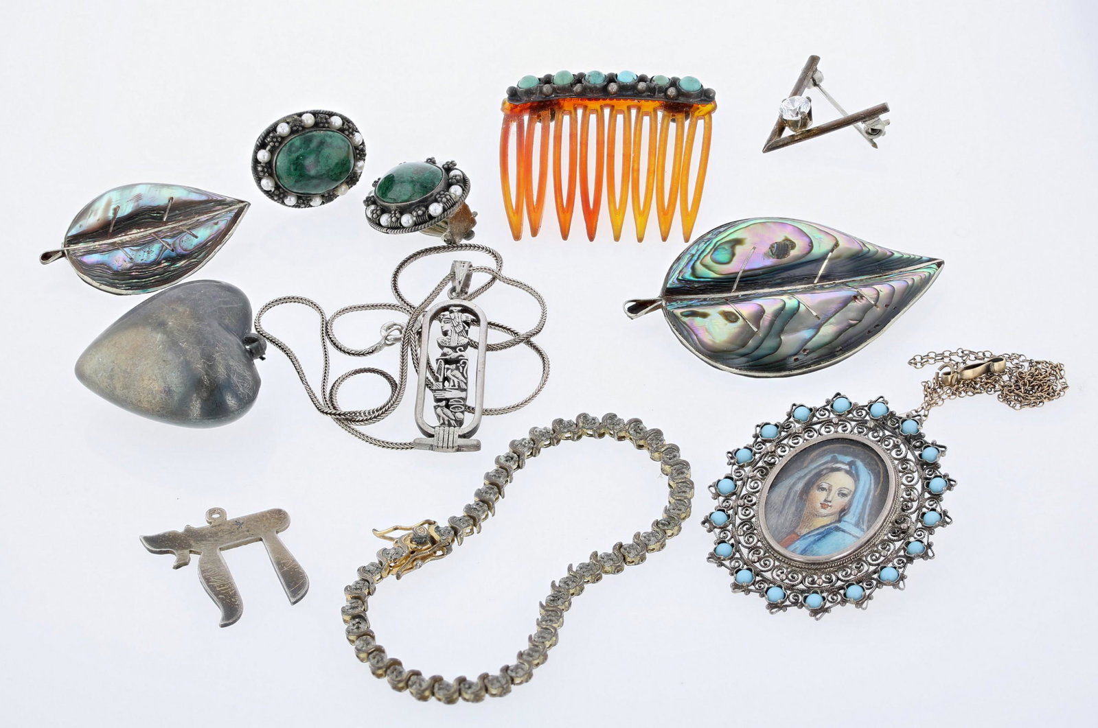 Silver Jewelry Group: Silver jewelry group c/o; (1) southwestern silver hair comb, (1) 800 silver oval portrait pendant /pin, stamped 800, ornate filigree frame (1) pair of chrysocolla ear clips, framed by pearls, signed E
