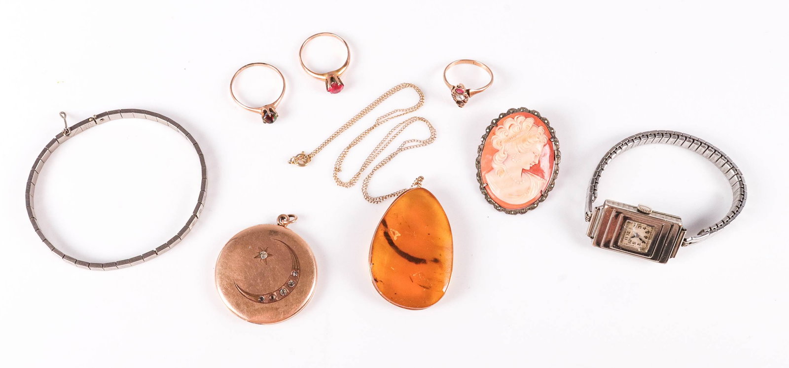 (8) Vintage Jewelry Lot: (8) Vintage Jewelry Lot c/o; (1) 800 silver cameo brooch, 1.5x1.25" (1) Gold filled locket, with pictures, missing one stone 1.5", (1) 18" gold filled amber necklace, (1) unmarked white tone art deco 