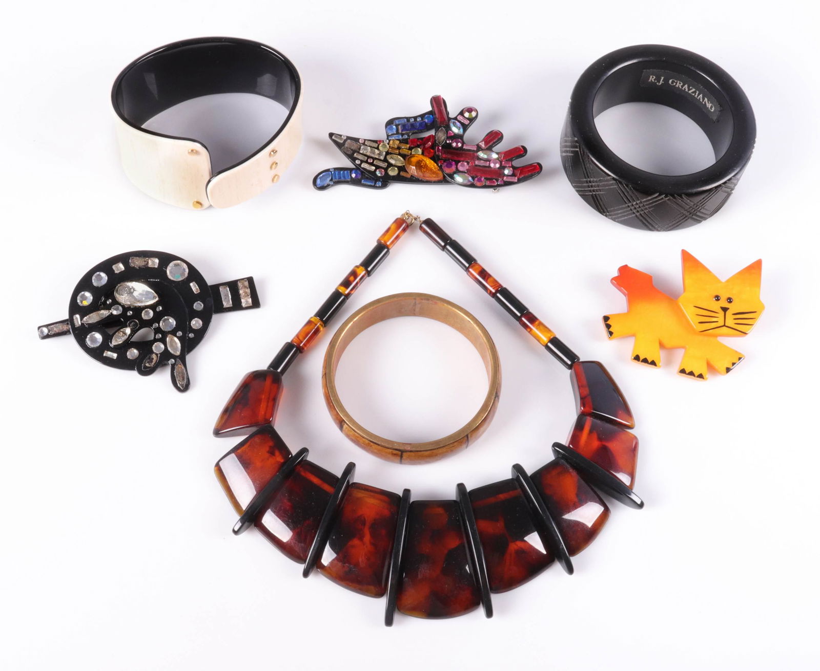 (7) Pc Contemporary Designer Fashion Jewelry Group: (7) Pc Contemporary Designer Fashion Jewelry Group c/o (2) 1980's artisan made brooches by Bill Schiffer, missing some rhinestones, (1) plastic tortoise shell statement necklace, (1) Pavone yellow cat
