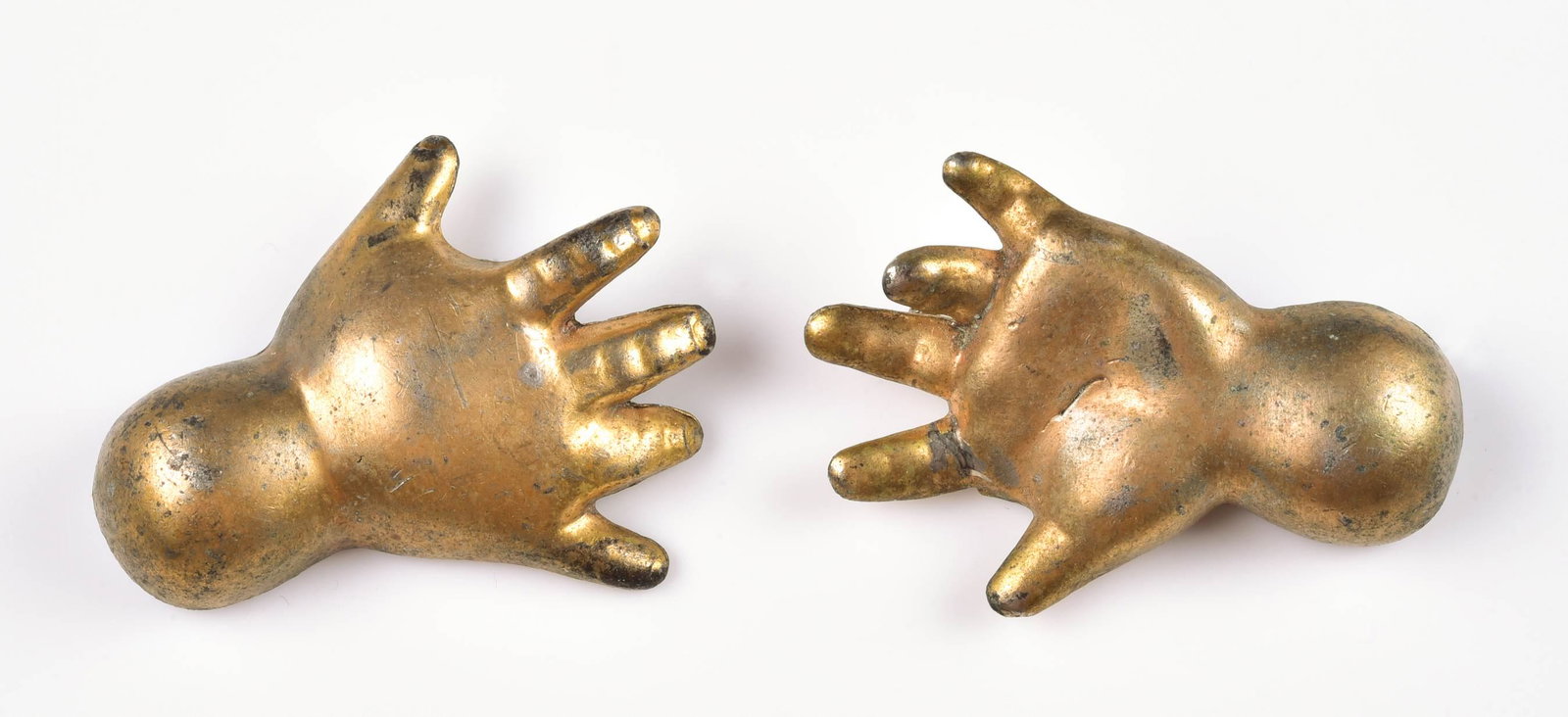 (2) Chanel Reinad baby hand brooches: A pair of Chanel Novelty Co.Reinad baby hand brooches. approx. 2" each, brass tone, scrip chanel 1940's.