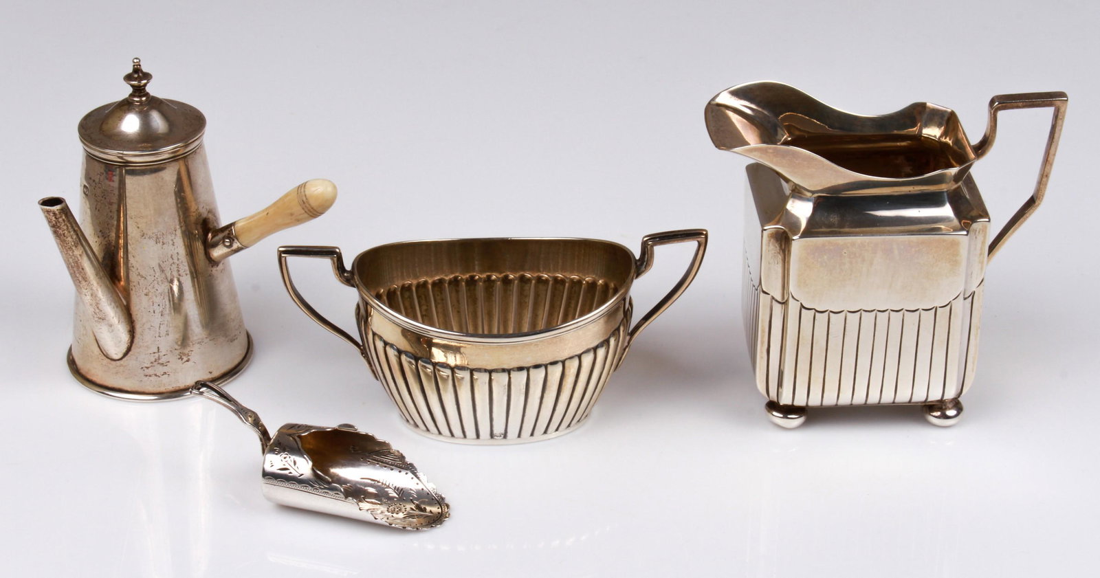 (4) Sterling Table Articles: (4) Sterling table articles to include 1891 Thomas Bradbury and Sons London creamer and sugar, marked Miller and Sons Piccadilly at underside, C.E Williams Birmingham bright cut sugar scoop, 2-5/8" L,