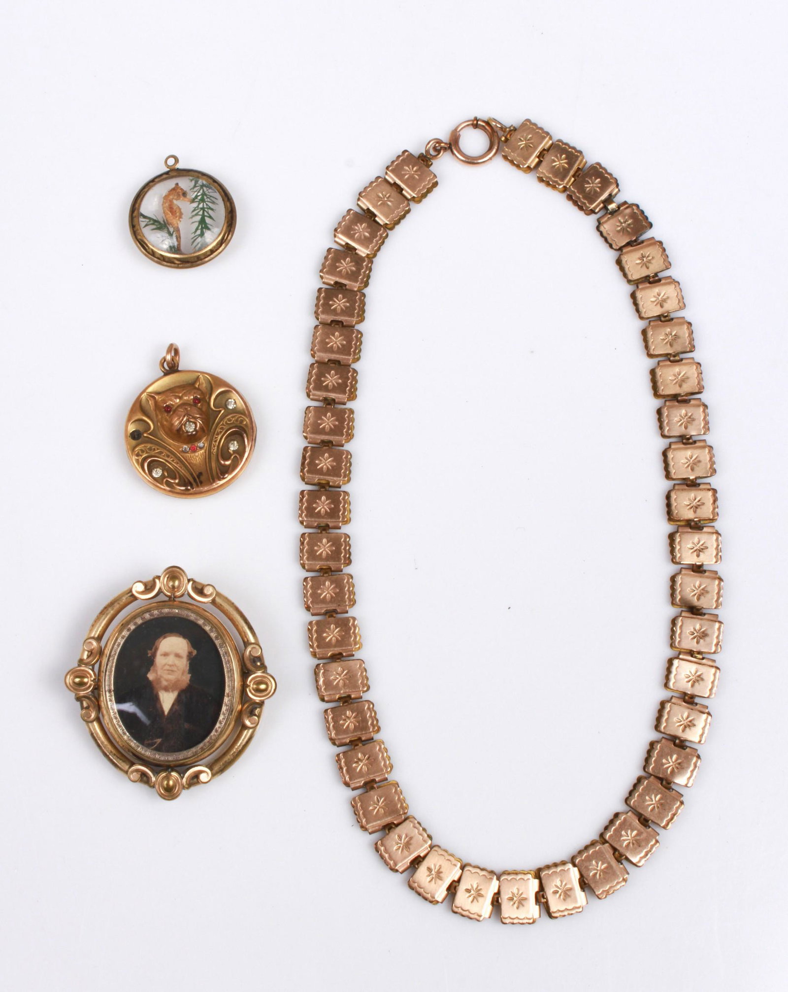 (4) Gold Filled Jewelry lot: (1) Gold Filled necklace, 17" long, (1) Gold filled seahorse pendant, missing jumpring, (1) 1.25" gold filled bulldog pendant. Mssing one stone, marked S&RL", and (1) Victorian double sided flip pin w