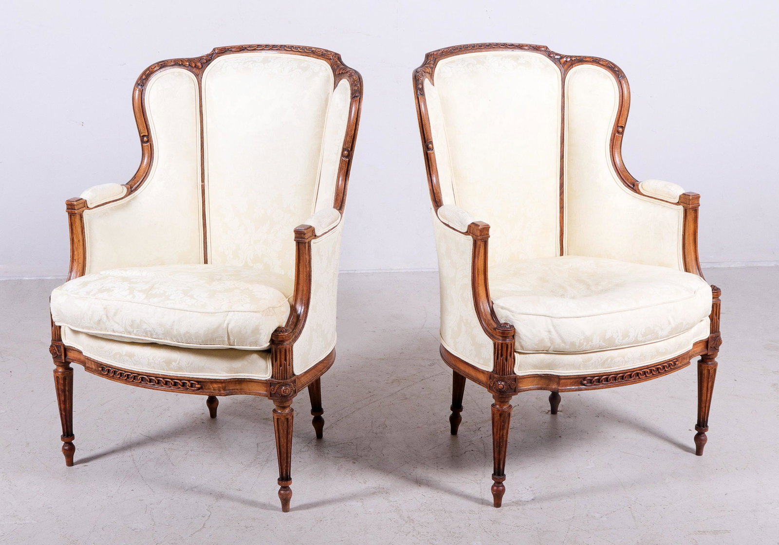Pair Louis XVI Style carved walnut upholstered bergeres: Pair Louis XVI Style carved walnut upholstered bergeres, yellow damask upholstery, tapered reeded legs, 39"h x 26"w x 21"d