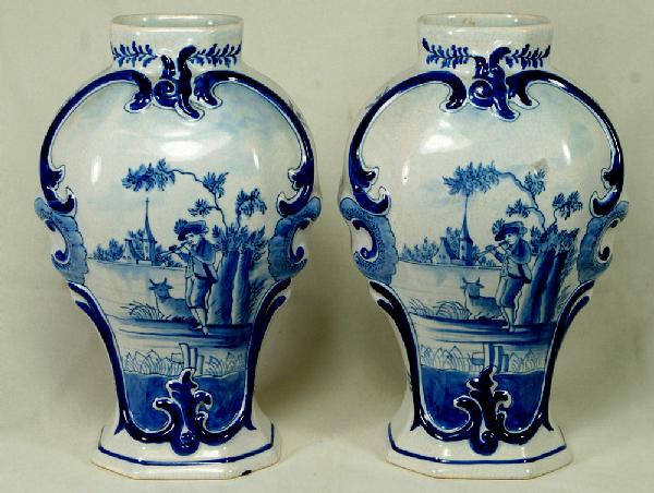 Pr of Dutch blue and white faience vases, measurin: Pr of Dutch blue and white faience vases, measuring 9 1/4" h, 19th/20th c, hairline crack to one at rim, large chip to base of the other, marked to base