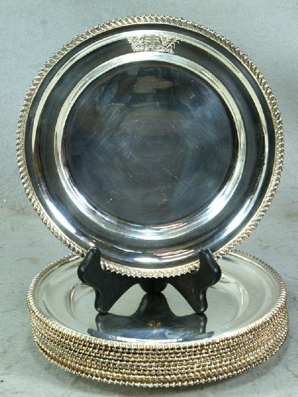 10+1 Irish silver dinner plates with gadrooned ed: 10+1 Irish silver dinner plates with gadrooned edge, Dublin marks with harp and hibernia, 20th c, by Royal Irish Silver Co, 9 1/2" d, engraved coat of arms, the one plate about 1/8" smaller, 176 TO
