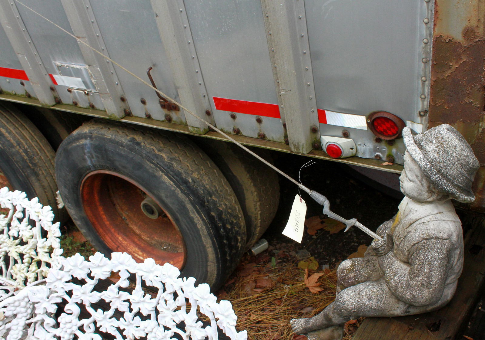 Concrete garden statue of a boy fishing: Concrete garden statue of a boy fishing, 37"h x 61"l