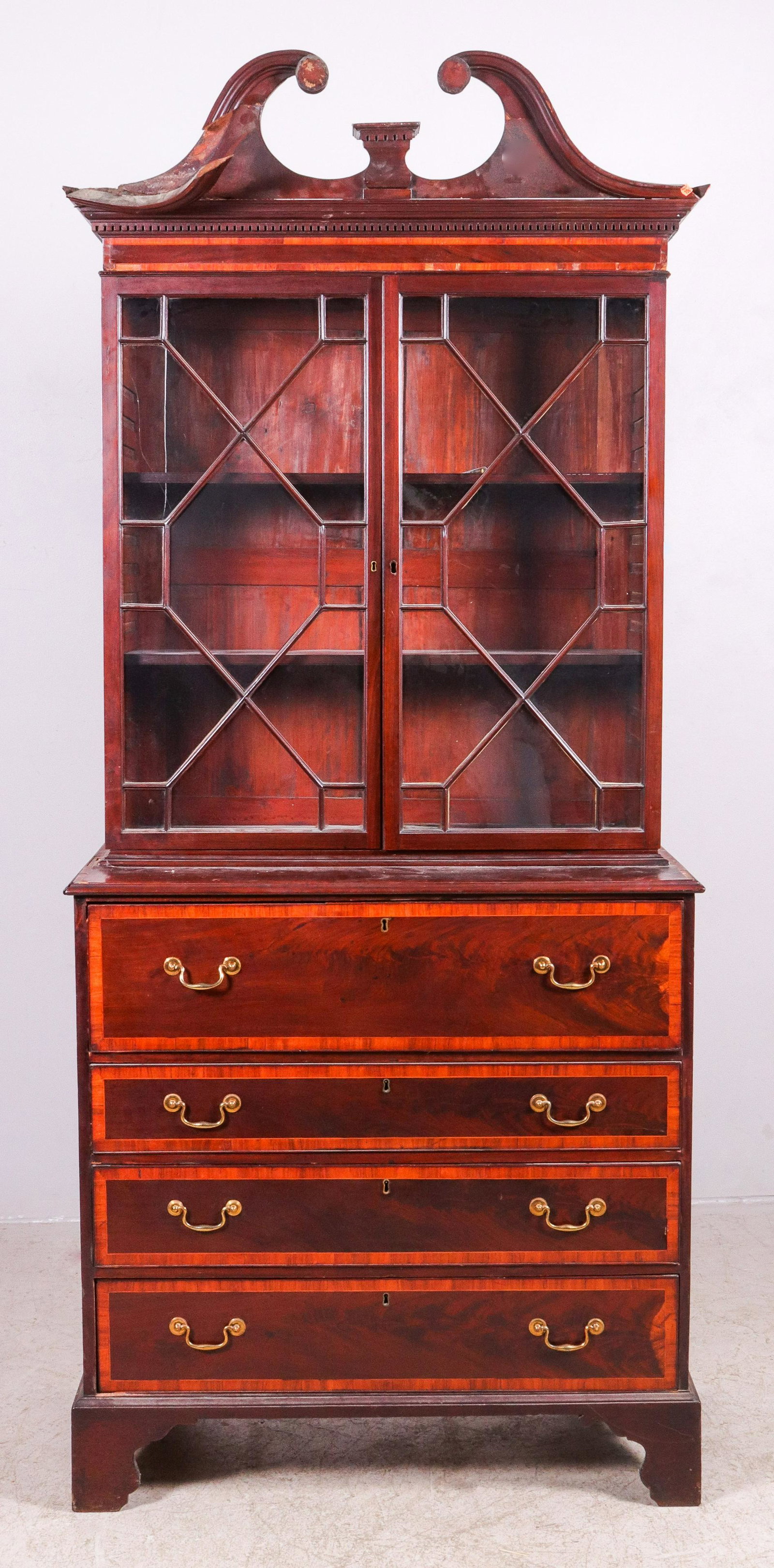 2-pc Mahogany inlaid butler's desk: 2-pc Mahogany inlaid butler's desk, scrolled open bonnet top over two glass doors over base with top desk drawer with fitted interior, over three drawers, 93"h x 40"w x 21"d, veneer damage, cracked bo