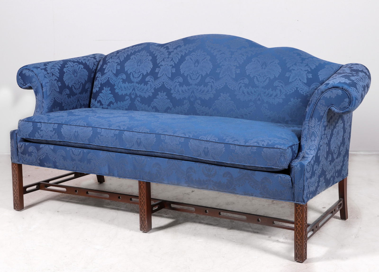 Sherrill Chippendale style camelback sofa: Sherrill Chippendale style camelback sofa, blue damask upholstery, carved mahogany stretcher, 37"h x 78"w x 32"d