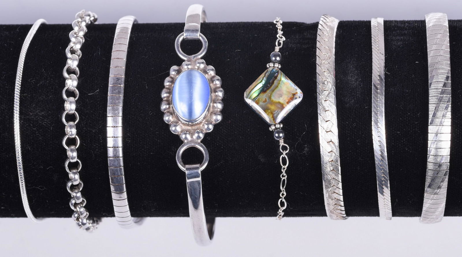 (8) Sterling Silver Bracelets: (8) Sterling Silver Bracelets, lot includes, link bracelets, herringbone, omega links and a hinged cuff bracelet w/blue stone.