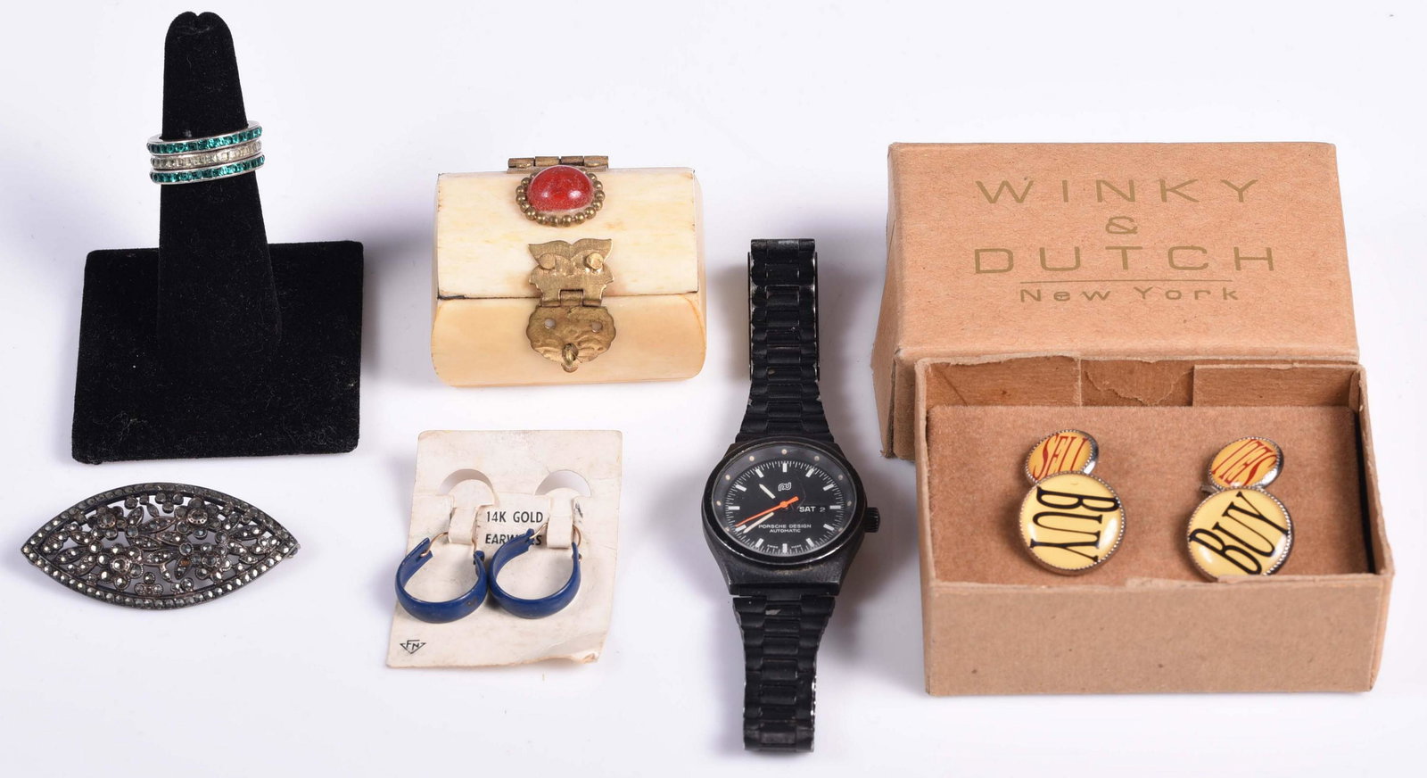Mixed Jewelry Lot: (1) Porsche Design watch, black dial, not running, (1) pair of button cufflinks, "buy, sell" (1) carved bone box, (1) pair of hoop earrings with 14K gold wire, (1) Sterling silver and marcasite brooch