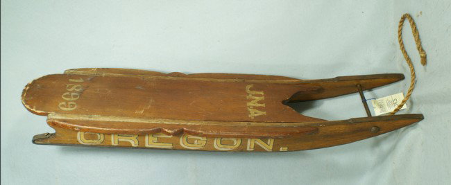Oak and pine sled, inscribed on bottom "Built by E: Oak and pine sled, inscribed on bottom "Built by E. G. Abbott, for James Abbott in Year 1875", old red paint, initaled & dated "J.N.A/1899" on top deck, aqnd "OREGON" on each side, 50" long