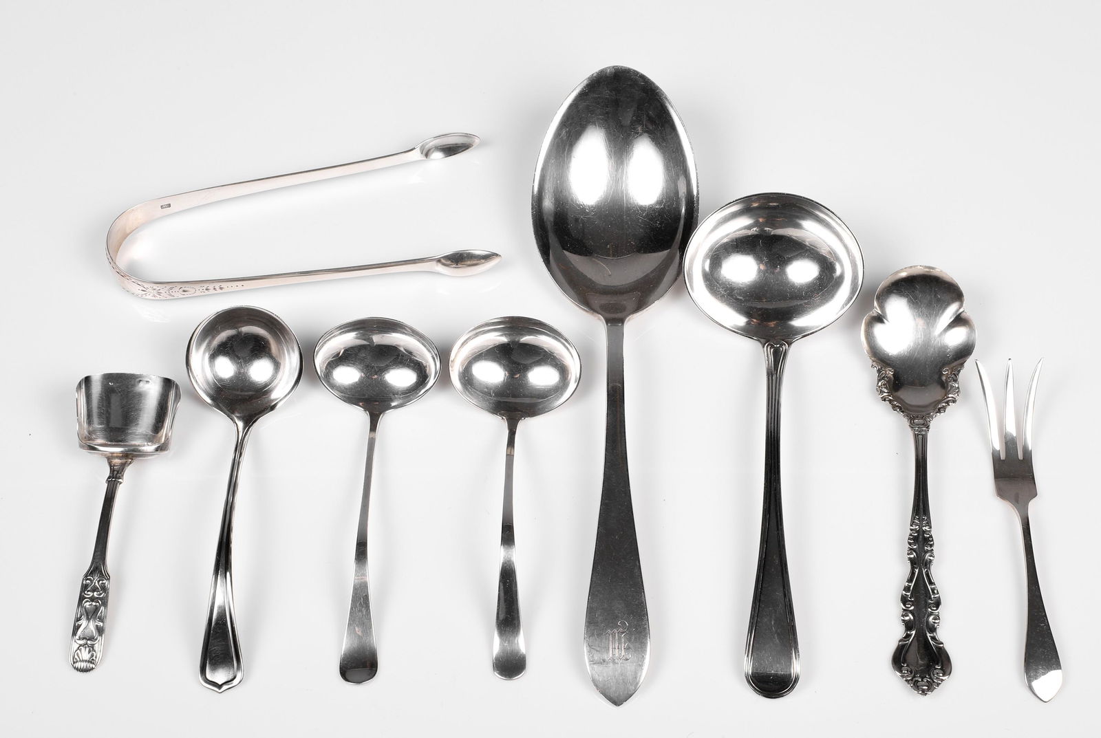 (10) Sterling Spoons and Serving Articles: (10) Sterling spoons and serving articles to include Dominick and Haff sterling serving spoon, 9" L, Christopher & Thomas Wilkes Barker London early 19th C sauce ladle, (3) small sauce ladles, 19th C