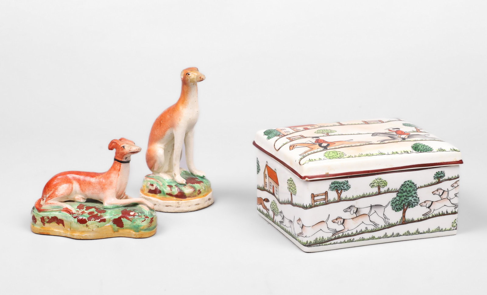 Crown Staffordshire Box and Whippets: Crown Staffordshire box and whippets to include Crown Staffordshire hunt scene covered box, 1/16" flake the rim, 4-3/4" x 3-3/4" and pair diminutive Staffordshire whippets, (1) with ear loss, 4-1/4" H