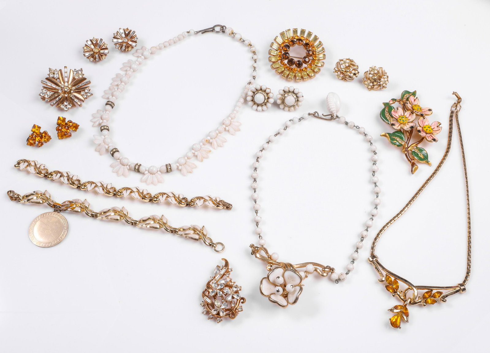 Vintage Costume Jewelry Group: Vintage costume jewelry group to include (2) gold tone white enameled bracelets, white enamel and gold tone floral necklace, white glass and rhinestone necklace, white glass and rhinestone screw back 
