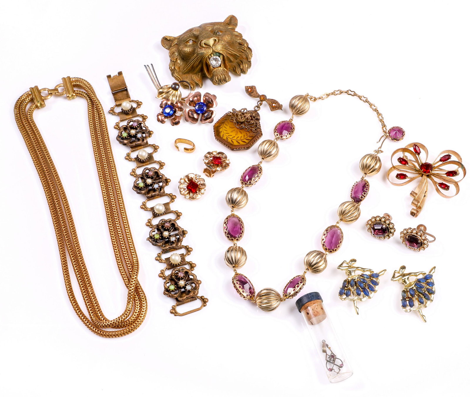Gold Filled and Gold Tone Jewelry Group: Gold filled and gold tone jewelry group to include gold tone lioness head belt buckle with rhinestone eyes and larger stone at mouth, 2-1/2" L, gold tone and purple glass necklace, screw back faux pea