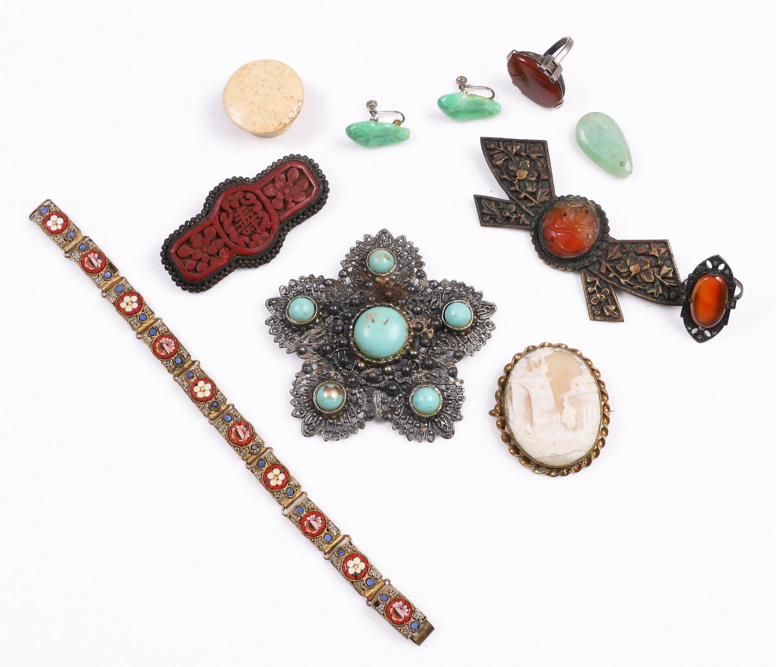 Asian and Style Jewelry Group: Asian and style jewelry group to include cinnabar carved pin, missing pin back, green hardstone bead, carved stone centered brass embossed pin, small bone trinket box, pair green hardstone earrings, g