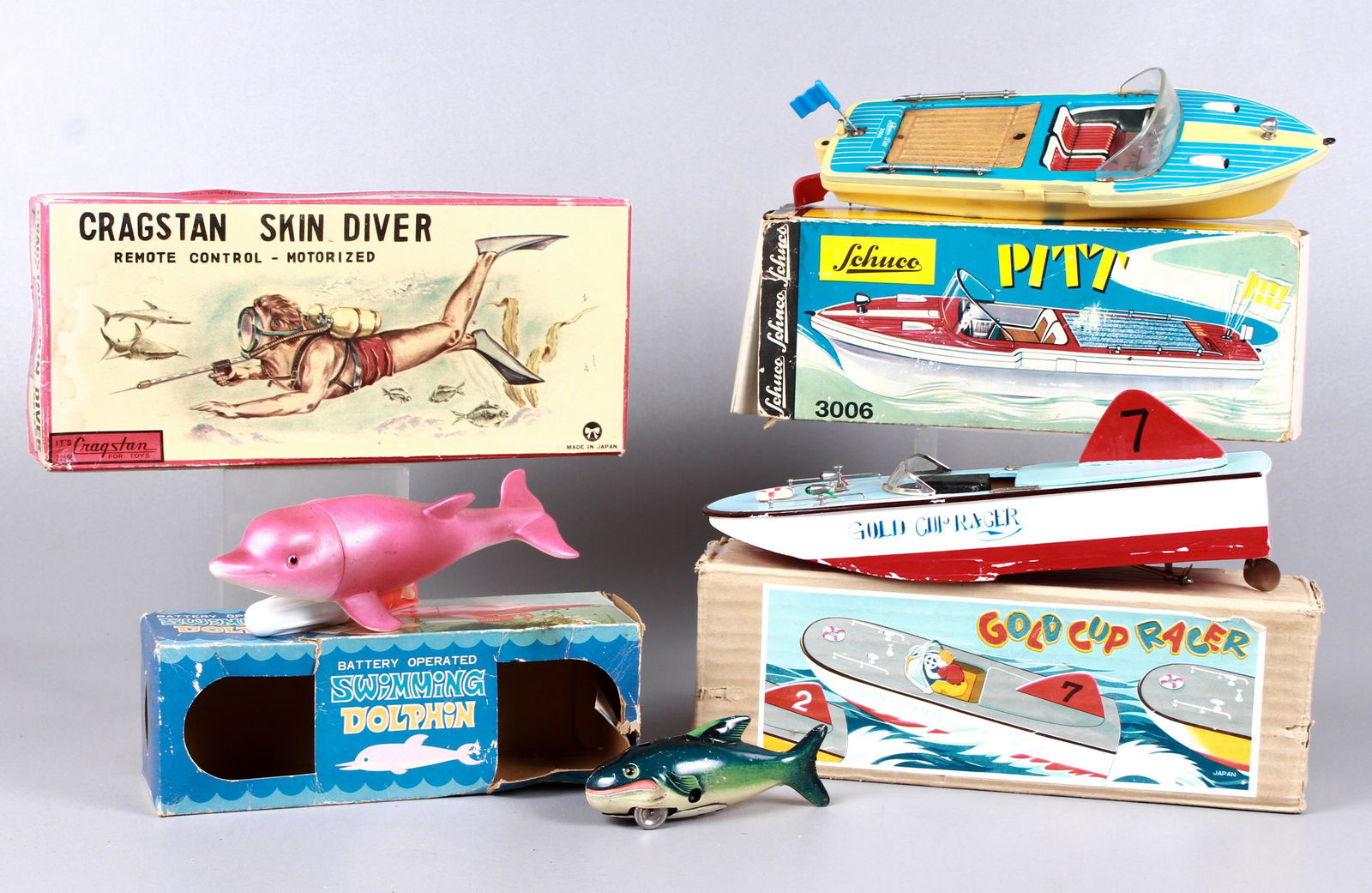 Vintage boat, diver and fish toy grouping: Vintage boat, diver and fish toy grouping to include US-Zone Germany wind up tin litho fish toy, 5-1/2" L, Cragstan battery operated diver, damage to to legs and body, in original box, Gold Cup Racer