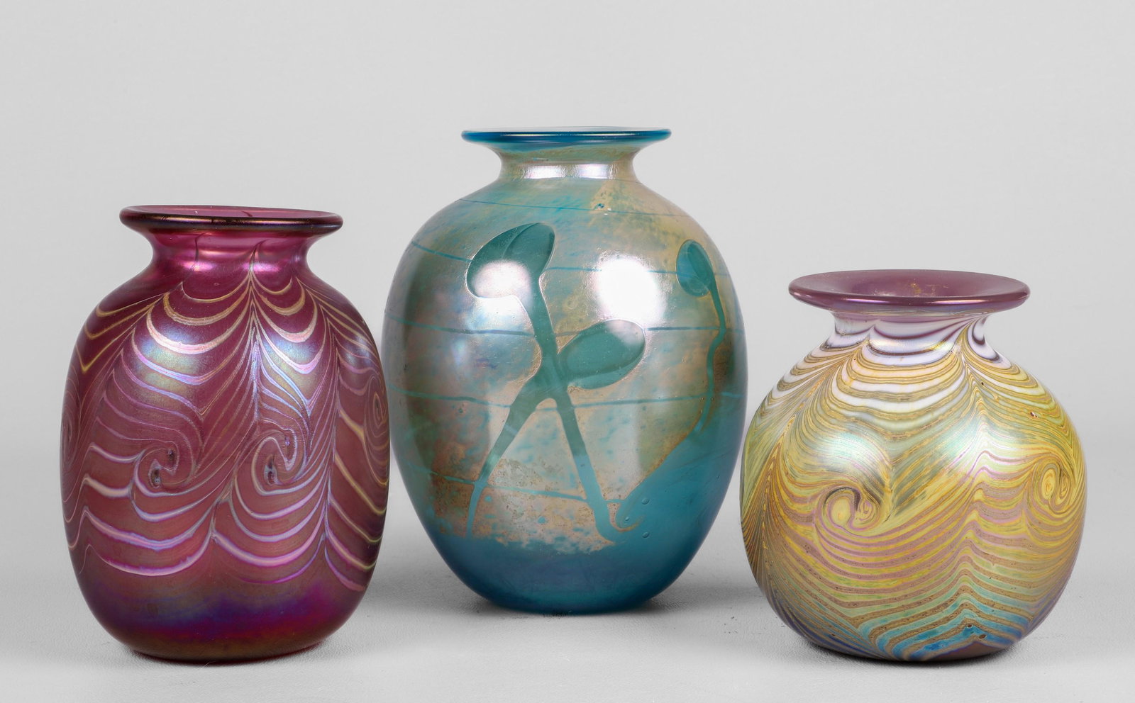 (3) Iridescent Art Glass Vases: (3) Iridescent art glass vases, c/o aqua & gold Bruce Freund '88 (5-3/4" h), pink feather pulled Jim Bush 1987 (4-3/4" h), lavender & gold feather pulled Jim Bush 1987 (4" h)