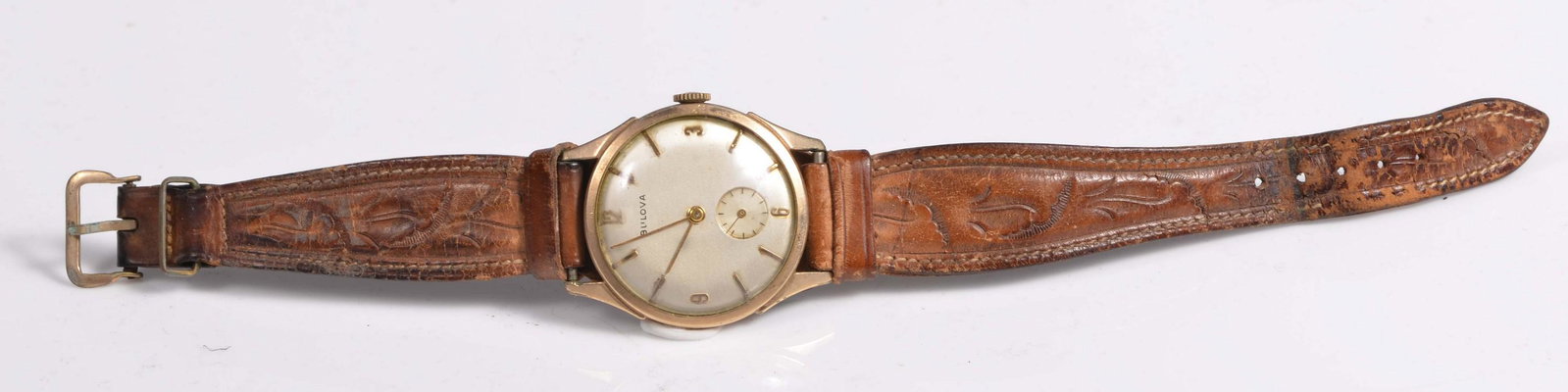 10K Rolled GF 1960s Mens Bulova Wristwatch: 10K rolled GF 1960's mens bulova wristwatch, runs when wound, no guarantee or warranty intended, on tooled leather band.