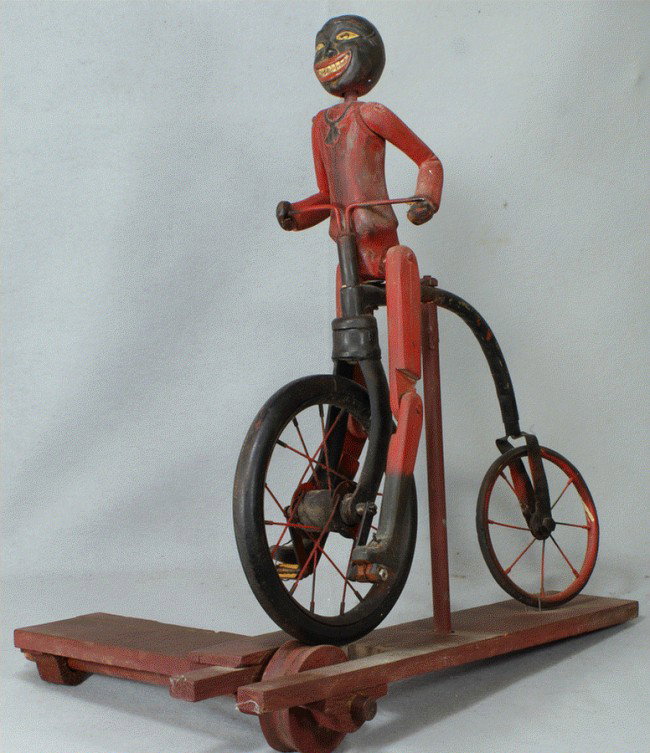 Wilbur Rowland, North East, MD, 20th c, carved and: Wilbur Rowland, North East, MD, 20th c, carved and painted whirligig, African American on High Wheel Bicycle, 24" long, 26 1/2" high