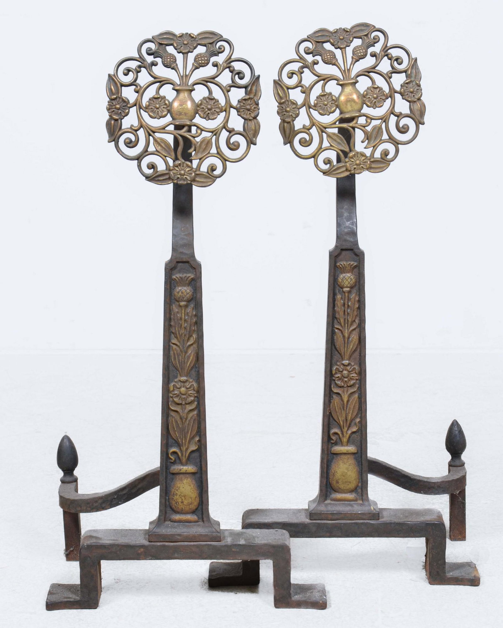Pair Arts and Crafts brass and wrought iron andirons: A pair of Arts and Crafts brass and wrought iron andirons, first half 20th century, height 30 1/2in; width 14 1/2in; depth 9in