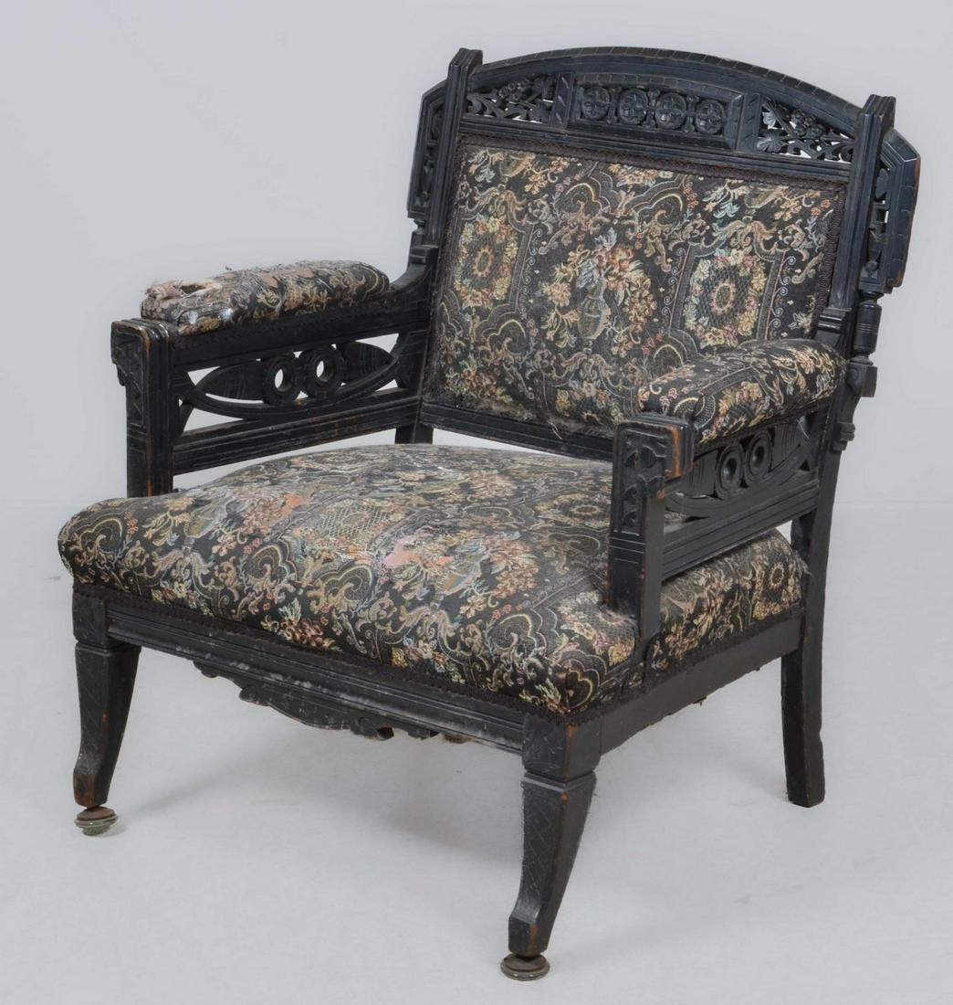 An Eastlake fret carved ebonized armchair, 19th C: An Eastlake fret carved ebonized armchair, fourth quarter 19th century, height 34 1/4in; width 31 1/4in; depth of seat 22in