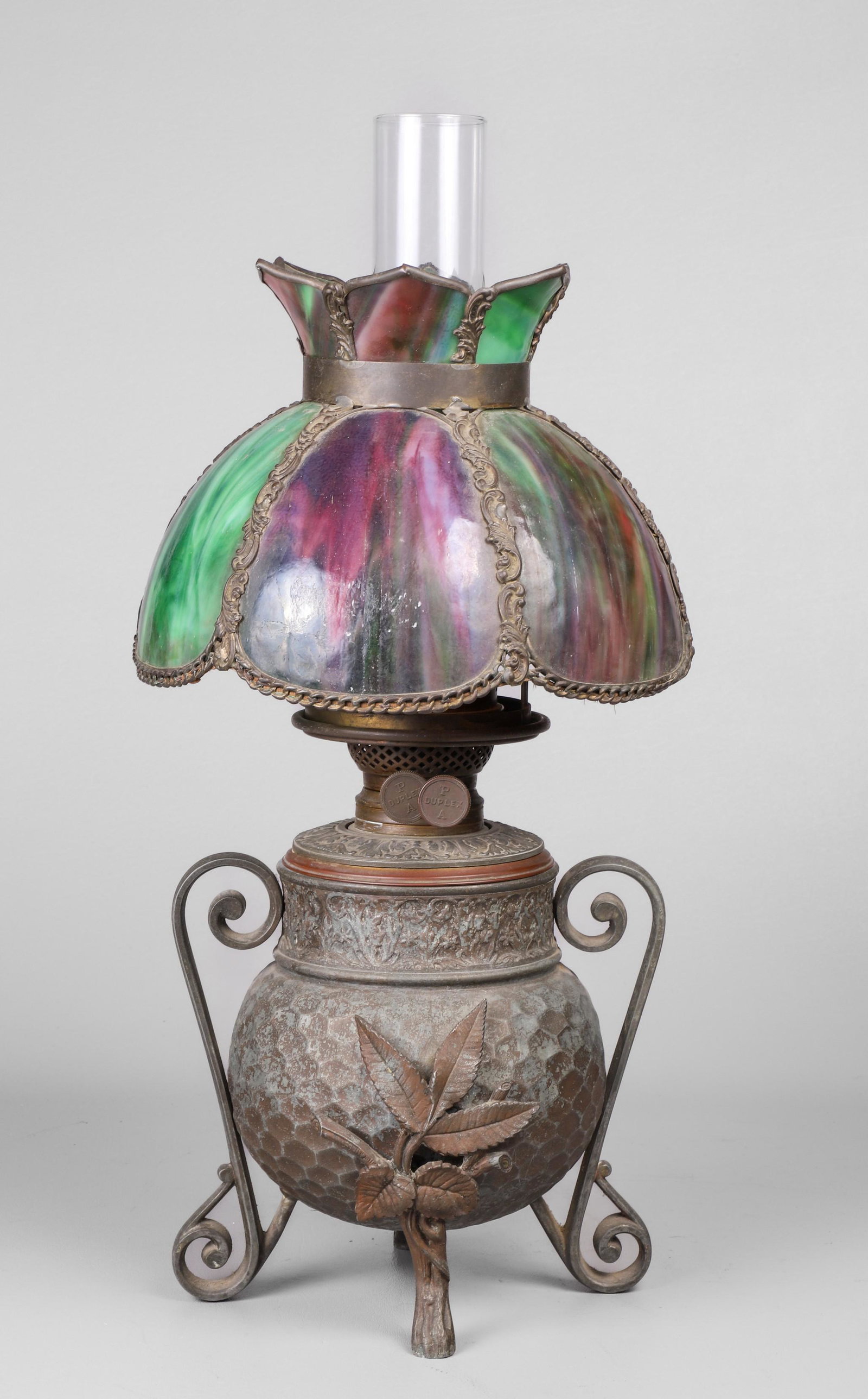 Arts and Crafts Slag Glass Oil Lamp: Arts and Crafts slag glass oil lamp c/o honeycomb patterned bulbous bodied white metal lamp raised on scroll and leaf form foot, double handled, with scroll embossed font, PA Duplex marked, with blown