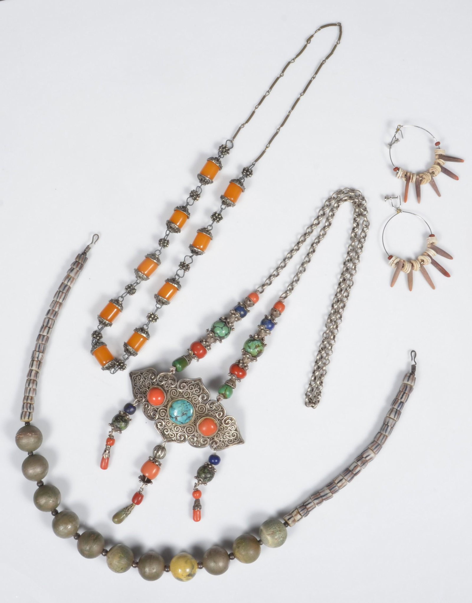 Ethnic Jewelry Grouping: Ethnic jewelry grouping to include hoop earrings with bone and stone beads, Moroccan Berber necklace with turquoise and coral bead and cabochon, on filigree silver tone plaque, trade bead style neckla