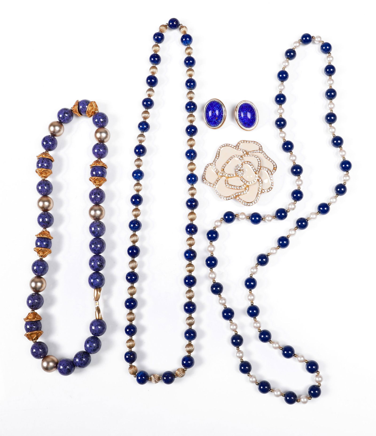 Lapis and Style Jewelry Grouping: Lapis and style jewelry group to include Ciner costume lapis style cabochon clip back earrings, similarly designed gadrooned gold tone and blue stone beaded necklace, blue bead and faux pearl necklace