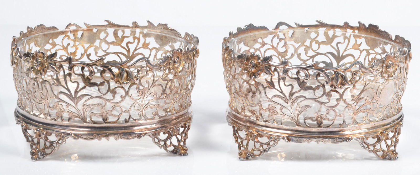 19th C Sterling Pierced Wine Coaster Pair: 19th C sterling pierced wine coaster pair, Joseph Angell I & Joseph Angell II, London, 1840, raised on pierced scroll foot with pierced sides in rocaille, scroll work and floral decoration, each with