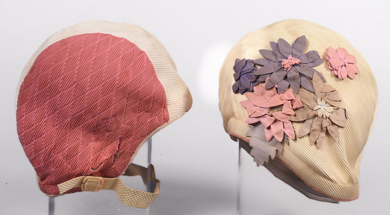 (2) 1950's Playtex Swim Caps: (2) 1950's Playtex swim caps to include ribbed cream swim cap with applied rubber floral decoration and pink diamond patterned and ribbed swim cap, both marked Playtex Made in Western Germany, for dis
