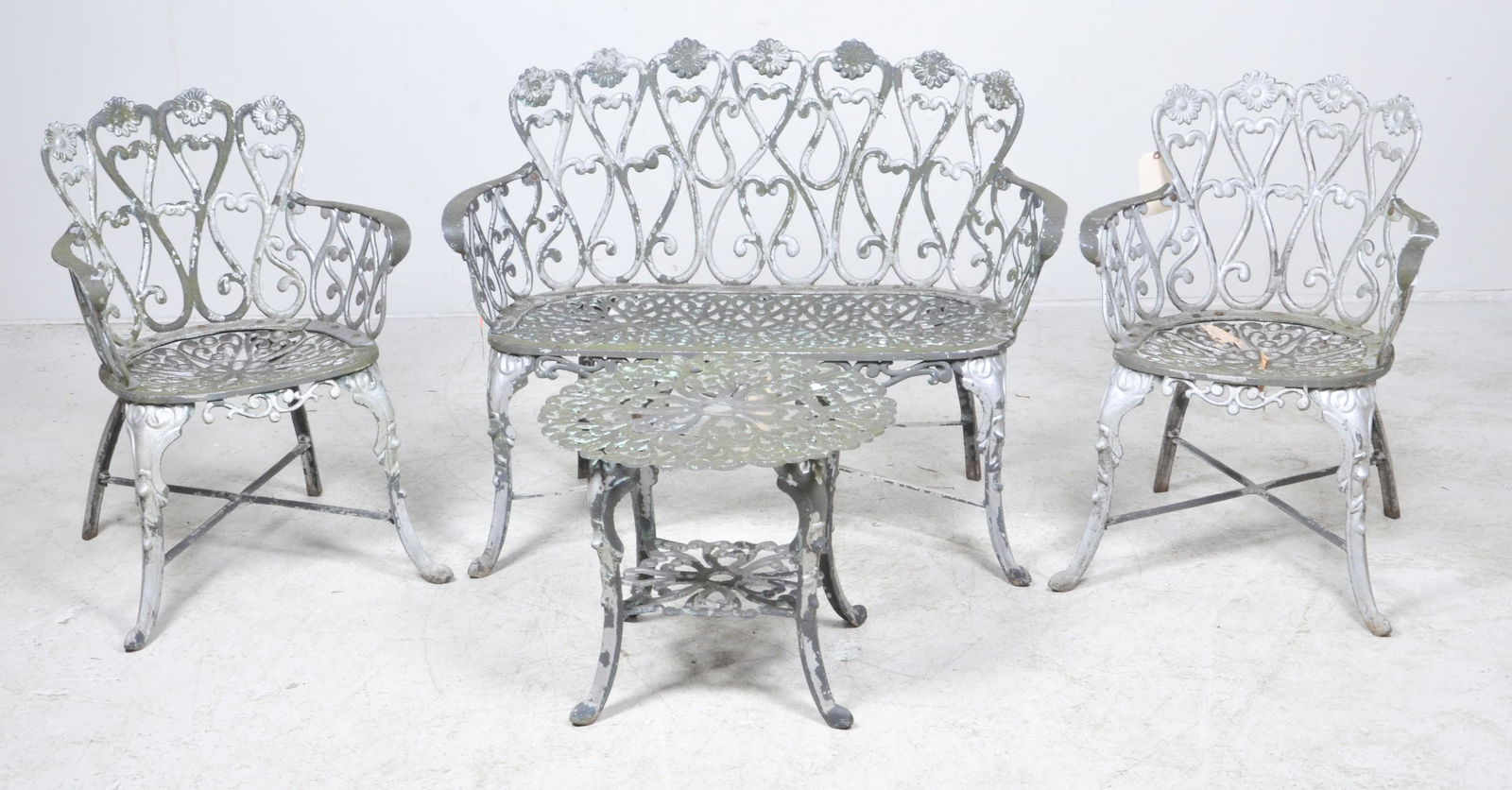 (3) pc Victorian style metal garden seating set: (3) pc Victorian style metal garden seating set, c/o pair armchairs and bench, green painted pierced white metal, bench 32-1/2"h x 42"w x 17"d, wear to paint