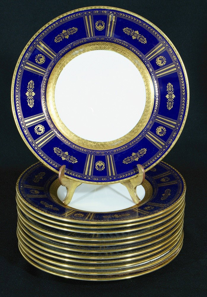 (12) Minton cobalt blue and gold service plates, m: (12) Minton cobalt blue and gold service plates, made for J.E. Caldwell, very minor wear to interior gold border on the stacking consistent with age, 20th c, 10 1/2" dia