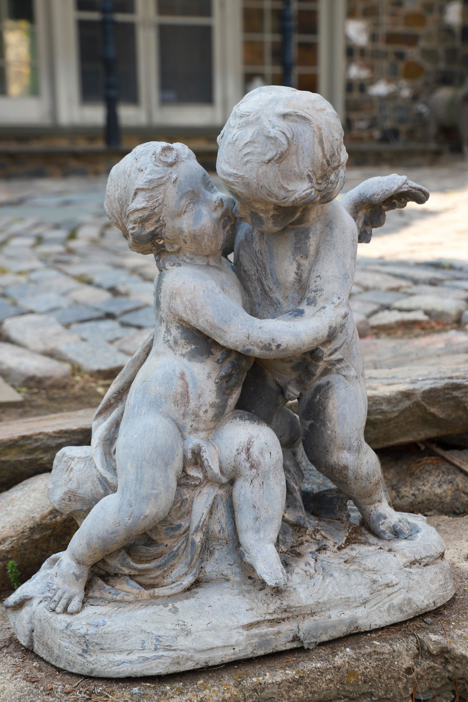 Garden statue of cherub holding putti (1 of 2)