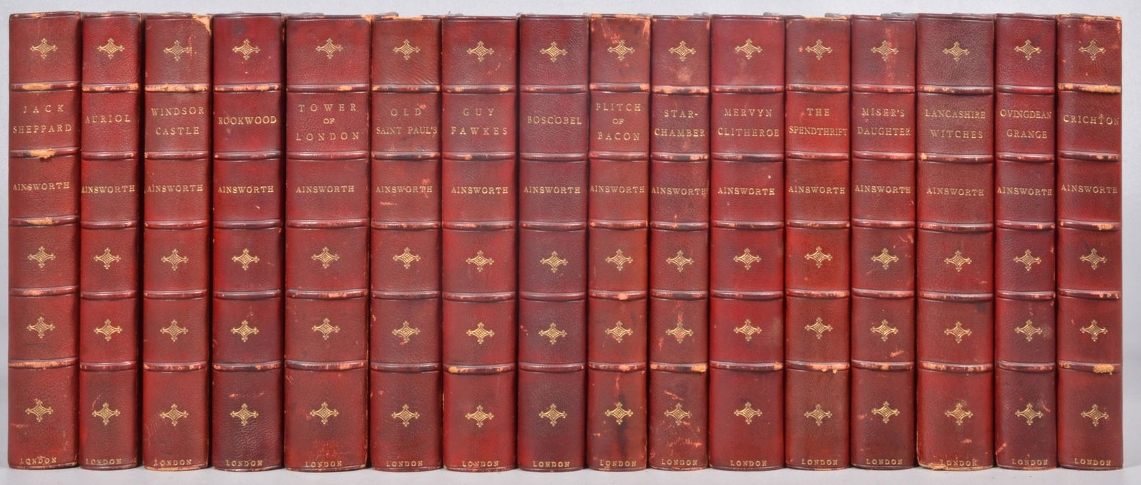 (16) 19th c. volumes of W. H. Ainsworth's novels: A set of sixteen novels by William Harrison Ainsworth, published in London in the late 19th century and bound in red half-leather and marbled boards, c/o Rookwood, Tower of London, Old Saint PaulÃ¯�