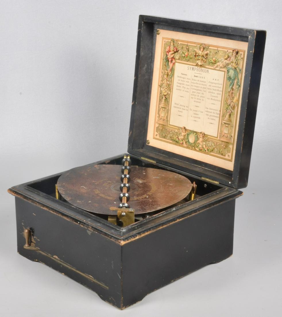 Symphonion Brevete Patent Disc Music Box: Symphonion Brevete Patent disc music box, Leipzig, Germany, late 19th C, lift top with parcel gilt polychrome patriotic motifs, interior lid with paper having a color border of musical figures and win