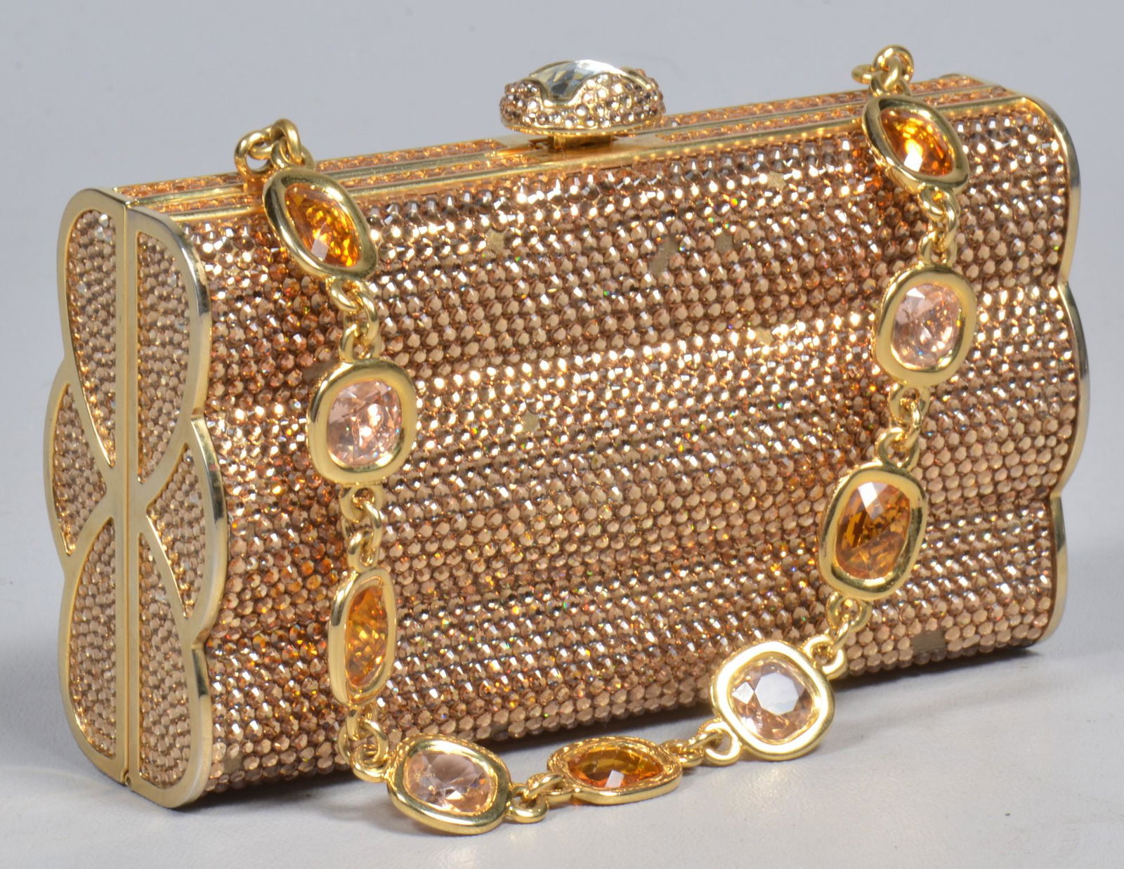 Judith Leiber Crystal Studded Minaudiere: Judith Leiber Crystal Studded Minaudiere, gold tone with Swarovski crystal allover adornment, faceted rhinestone set handle, 5-1/2"L, 3-1/4"H, with dustbag, few rhinestone losses, gold leather lined,